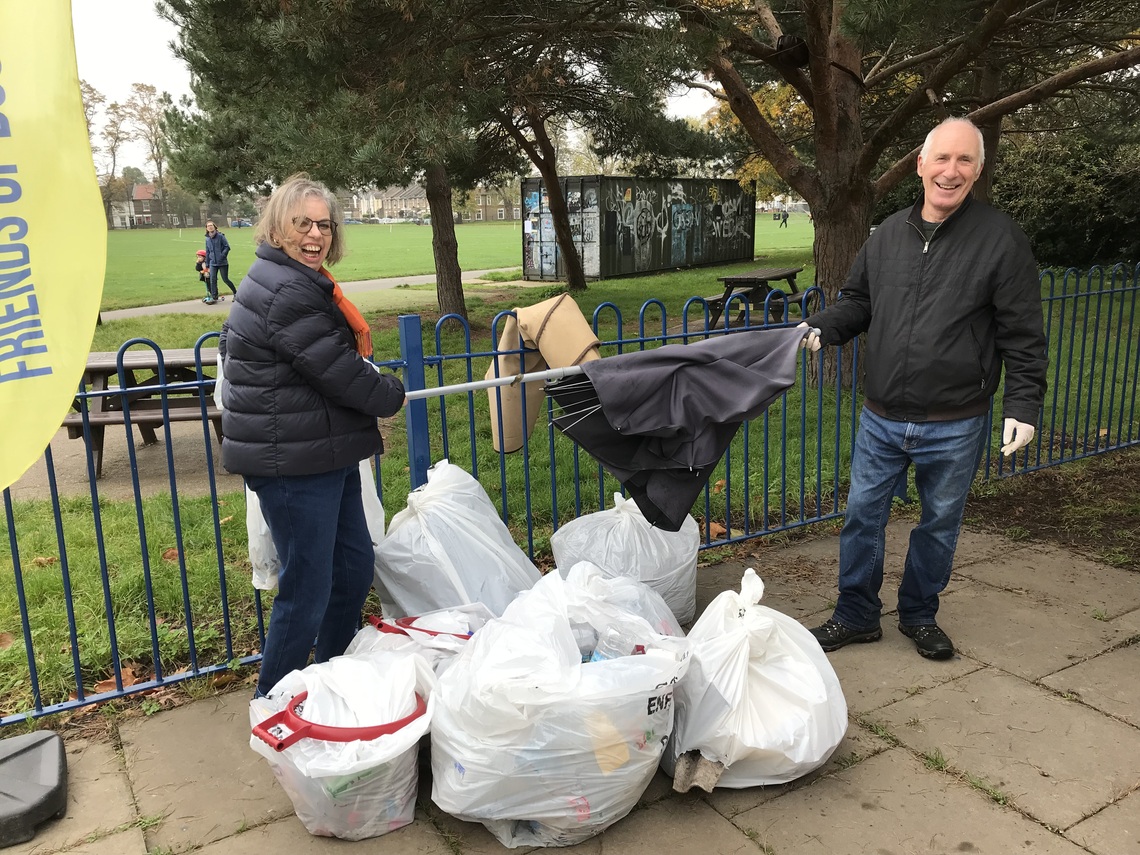 Two volunteers and litter picking bags