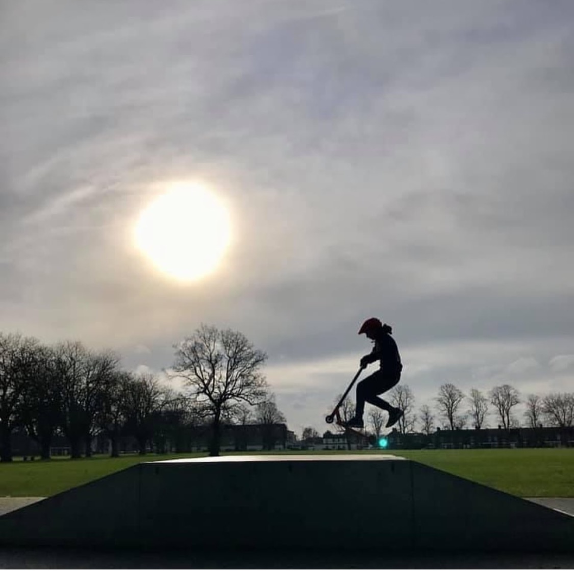 Backlit skate boarder/scooter person