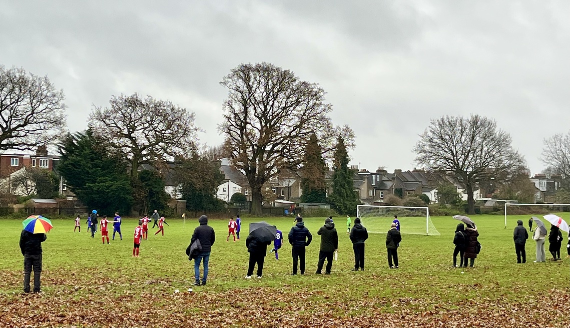 Junior football on a grey day in the park